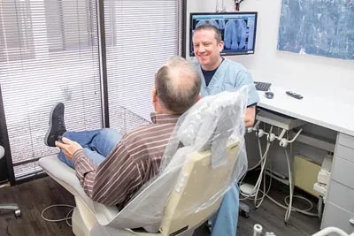 Dr. Alex Martin discussing how dental crowns can help restore a patient's smile